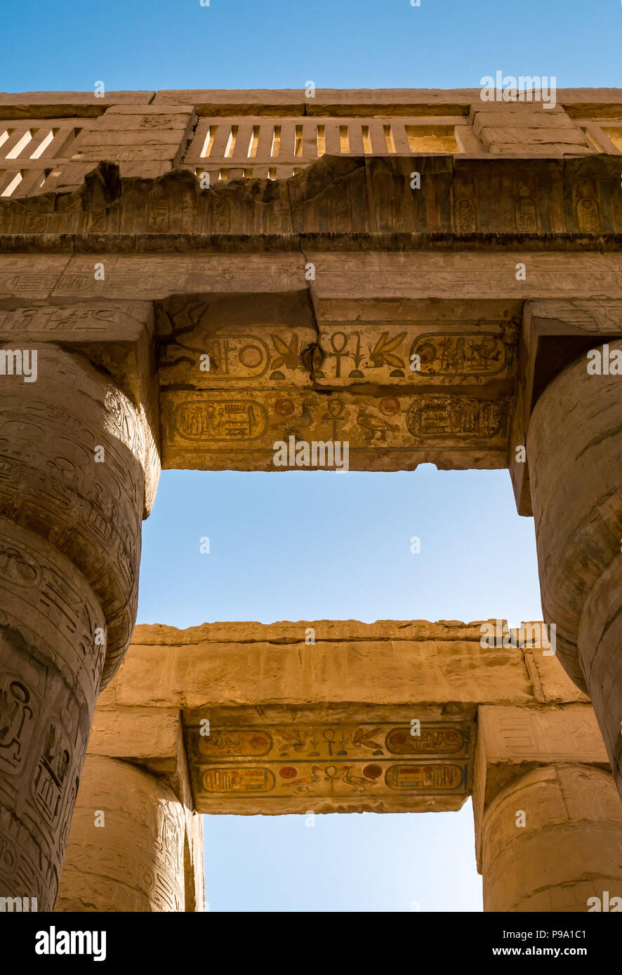 Looking up at colourful painted  Egyptian hieroglyphs at top of columns, great hypostyle hall precinct of Amun Ra, Karnak Temple. Luxor, Egypt, Africa Stock Photo
