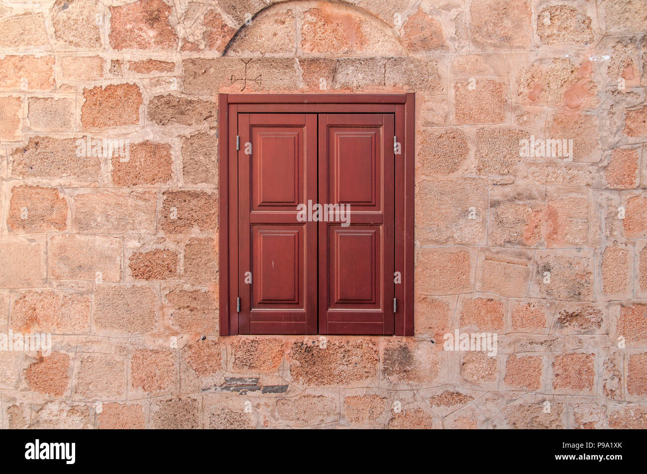 Red Frame Of One Modern Wooden Window On Yellow Castle Aged House