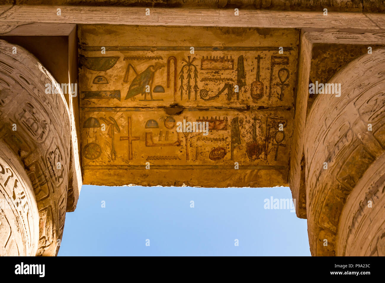 Colourful painted Egyptian hieroglyphs at top of columns, great hypostyle hall precinct of Amun Ra, Karnak Temple, Luxor, Egypt, Africa Stock Photo