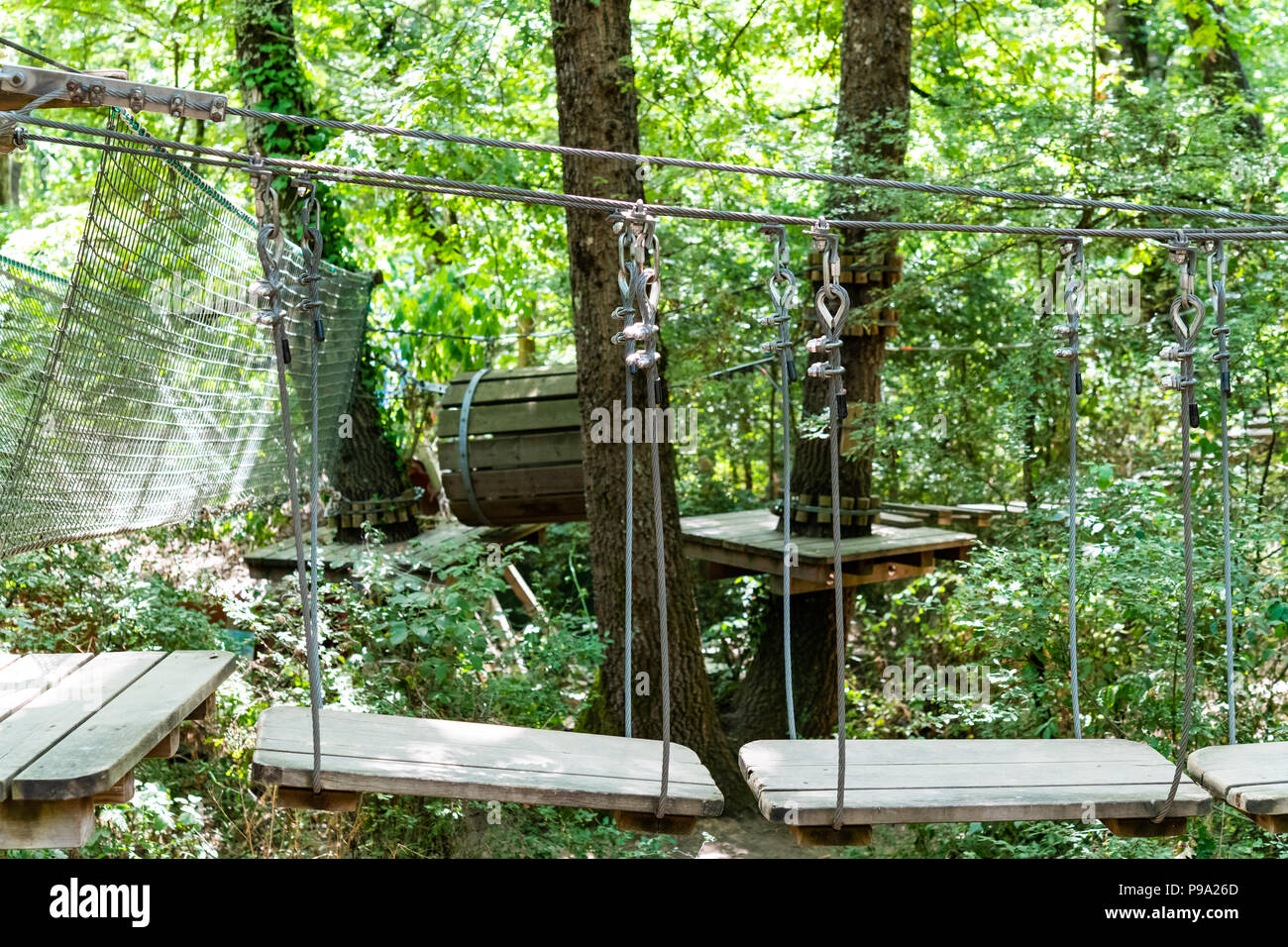 Way to challenge climbing and balance path in adventure playground in the forest Stock Photo