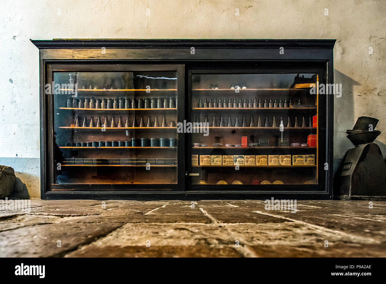 A cabinet of bottles and boxes in a corridor of the old Pharmacy and Apothecary 'Farmacia di S. Maria della Scala' in Piazza della Scala in Trastevere quarter, Rome, Italy Stock Photo