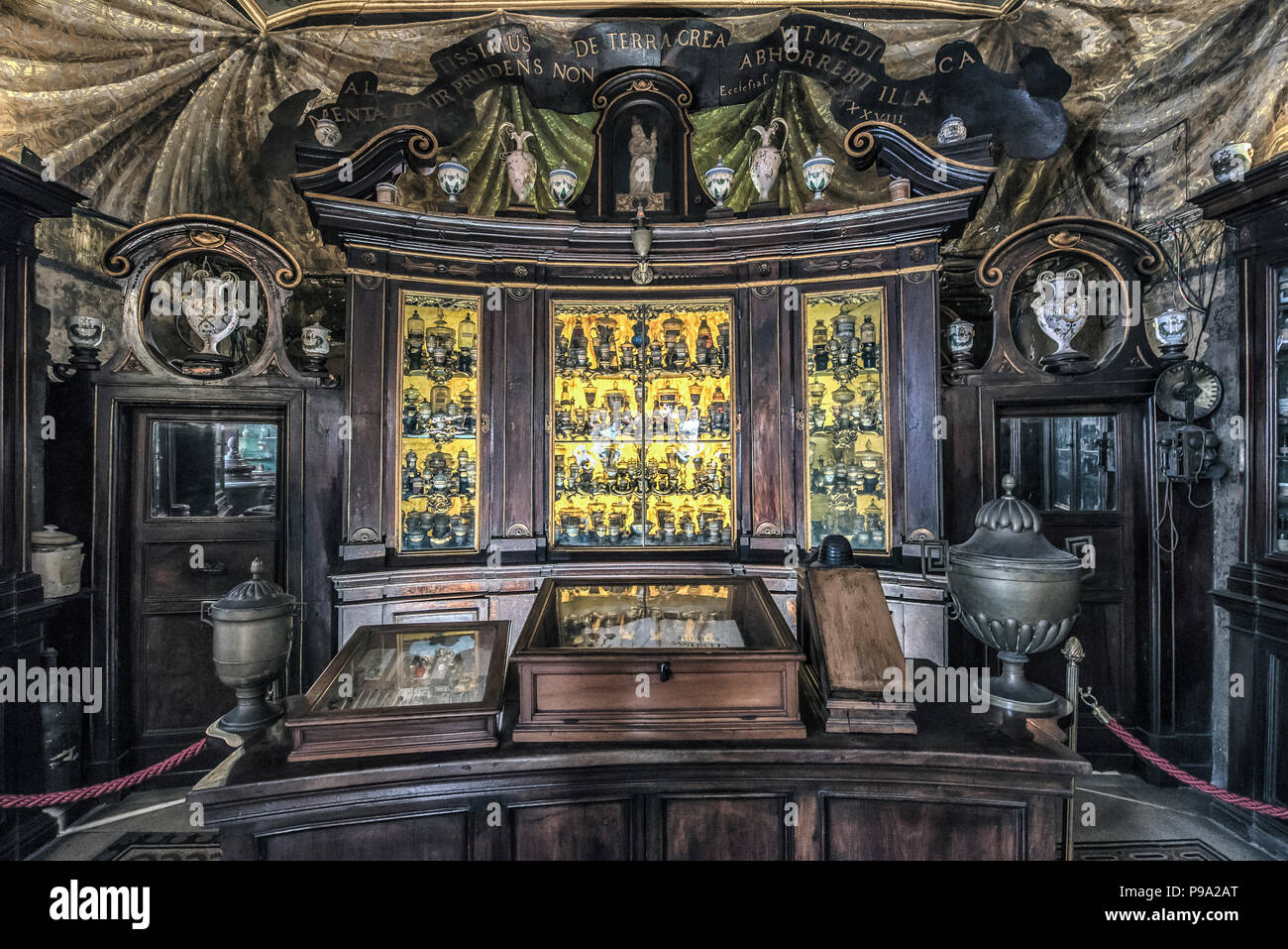 A golden cabinet at bottom to the old Pharmacy and Apothecary 'Farmacia di S. Maria della Scala' in Piazza della Scala in Trastevere quarter, Rome, Italy Stock Photo