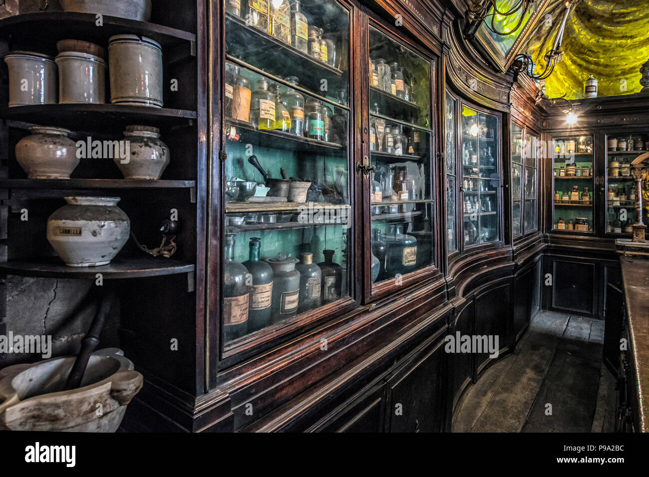 Cabinets and furnitures behind the desk of the pharmacist of the old Pharmacy and Apothecary 'Farmacia di S. Maria della Scala' in Piazza della Scala in Trastevere quarter, Rome, Italy Stock Photo