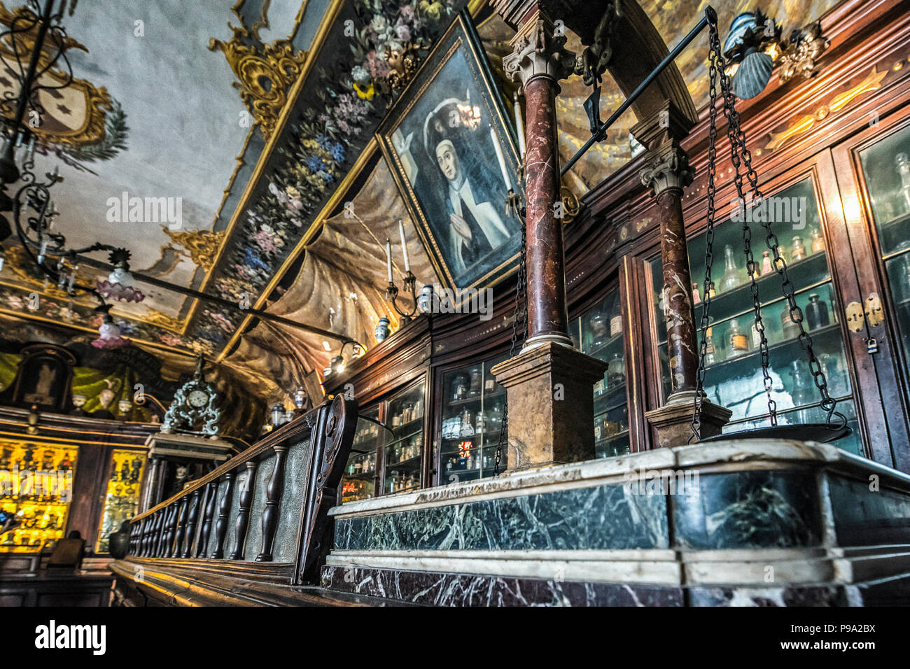 Desk, ceiling cabinets and furnishings of the principal hall of the old Pharmacy and Apothecary 'Farmacia di S. Maria della Scala' in Piazza della Scala in Trastevere quarter, Rome, Italy Stock Photo