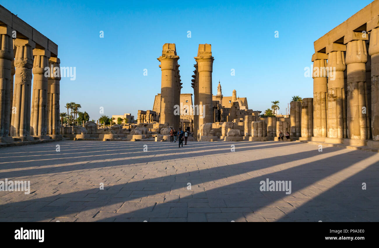 Tourists in Temple of Amon, Court of Amenhotep III, 1402-1364 BC colonnaded courtyard, Luxor Temple, Luxor, Egypt, Africa Stock Photo