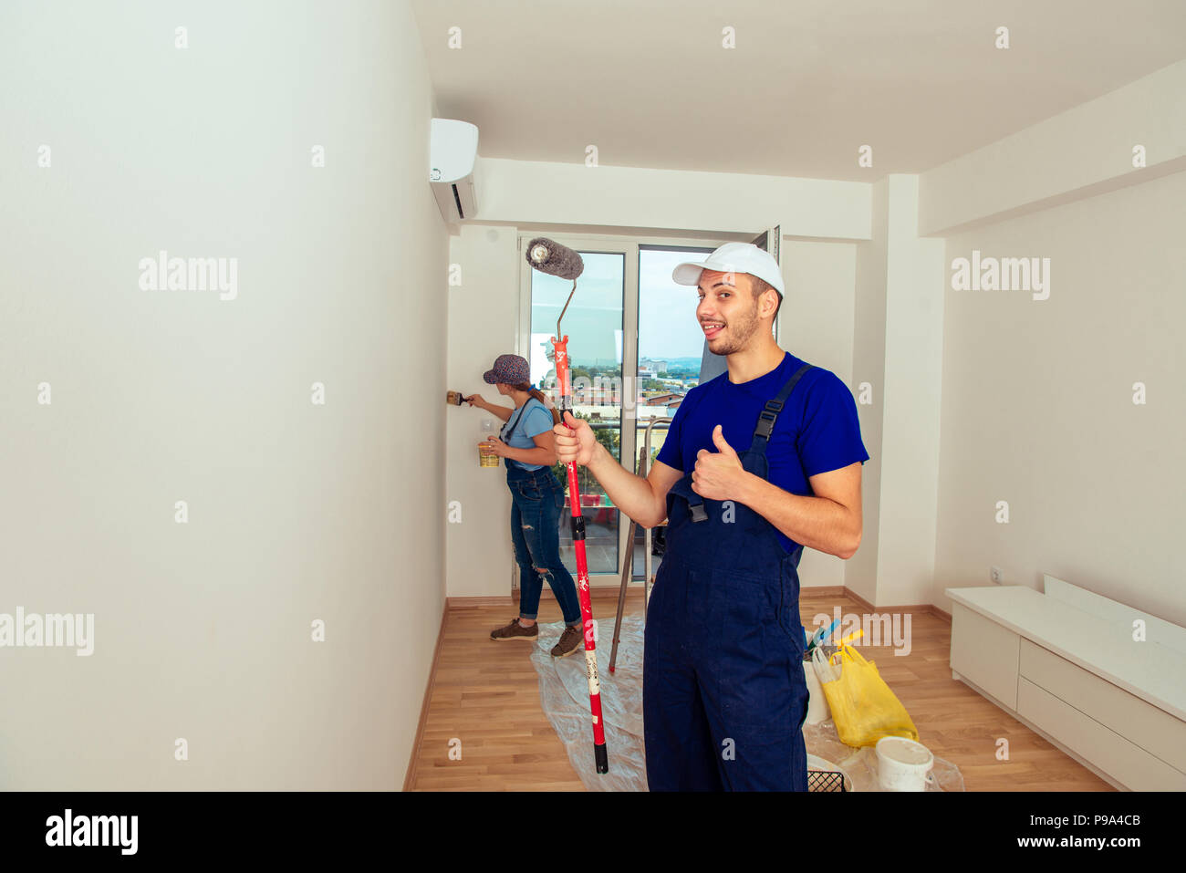 Young Family Doing Painting Job During Home Renovation Stock Photo Alamy