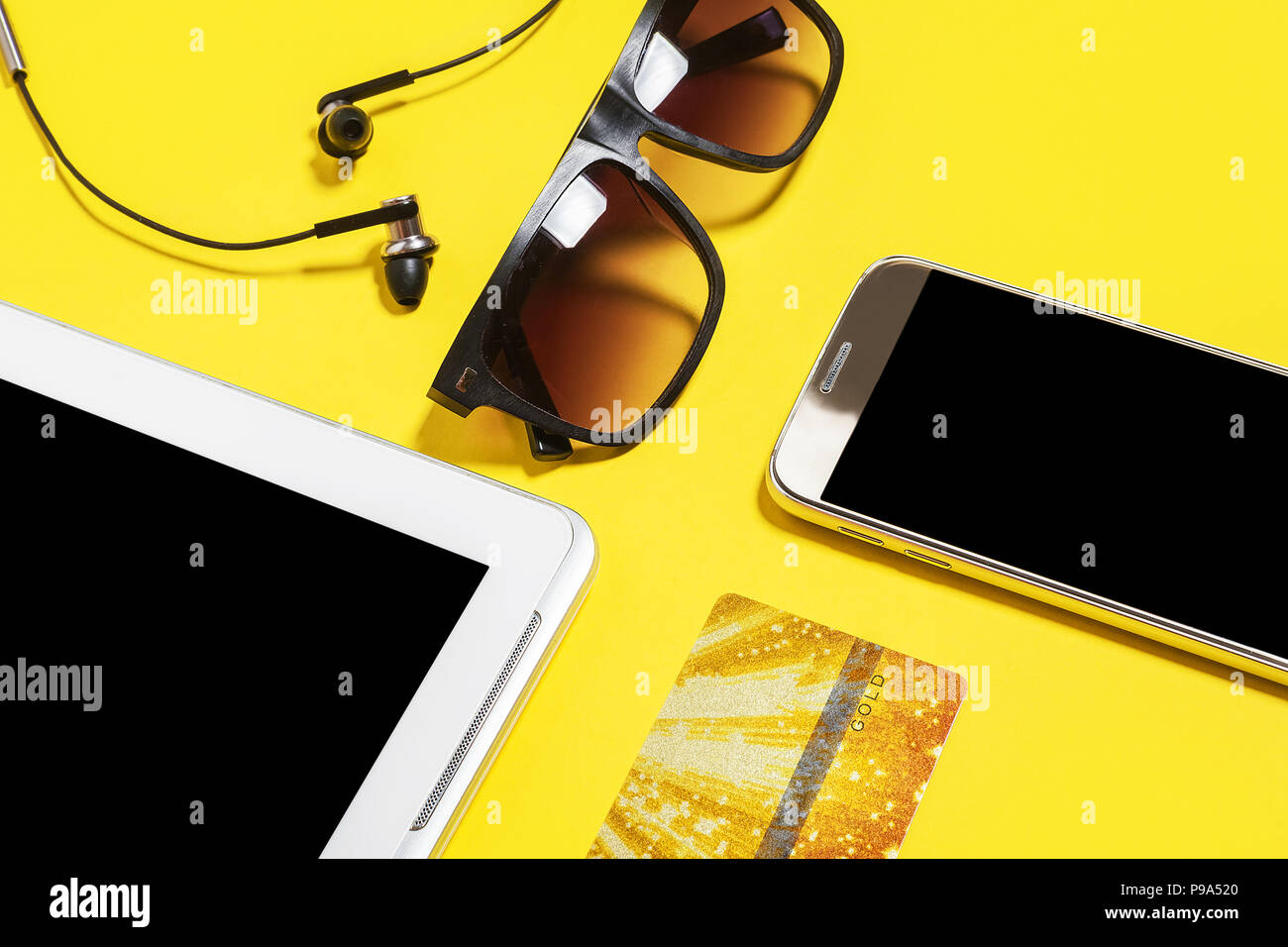 gadgets and accessories on a yellow background Stock Photo