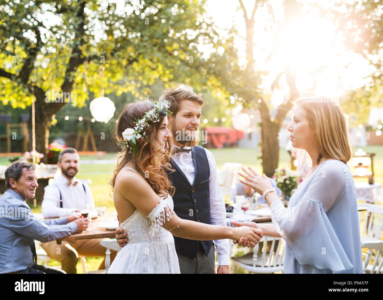 Young Girl Congratulating Bride And Groom At Wedding Reception In