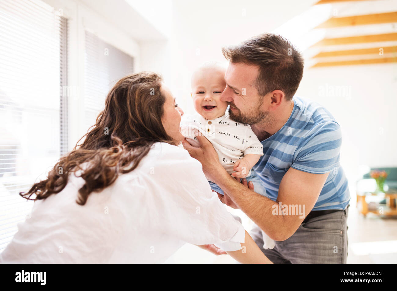 Young family with a baby boy at home, having fun. Stock Photo