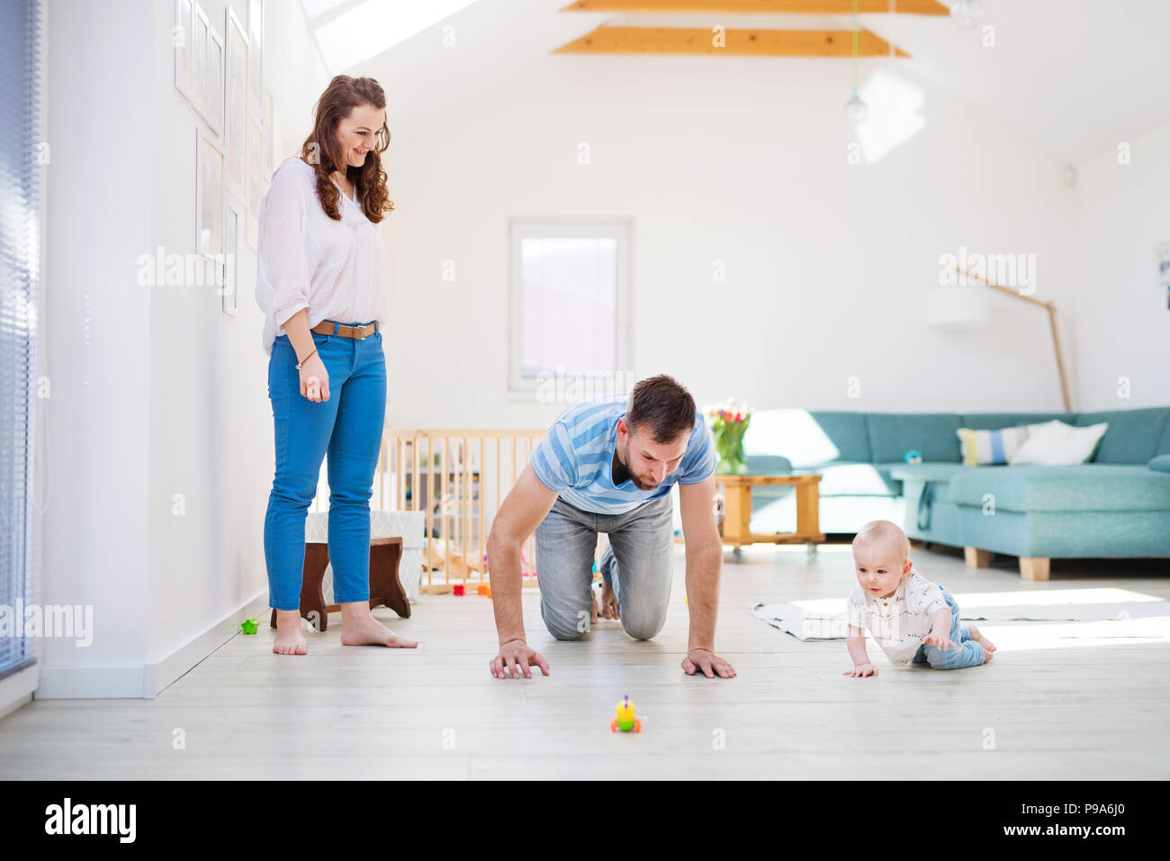 Young family playing with a baby boy at home. Stock Photo