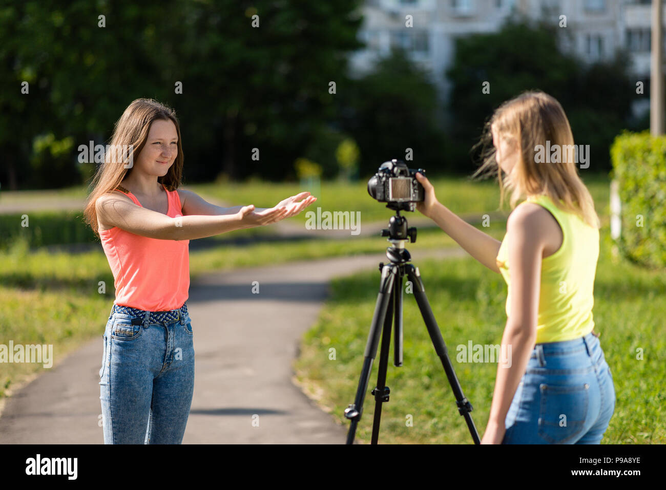 Two girls are students. Summer in nature. Conduct a conversation. Record  vlog and blog. Record video lesson for Internet. Use camera with tripod  Stock Photo - Alamy