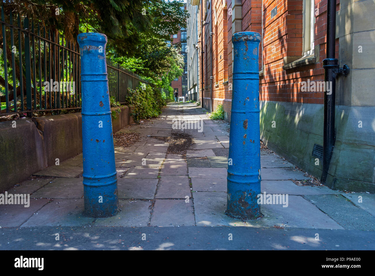 Two early 19th century cast iron cannon barrels used as bollards, St. John's Passage, Manchester, England, UK.  Grade II listed. Stock Photo