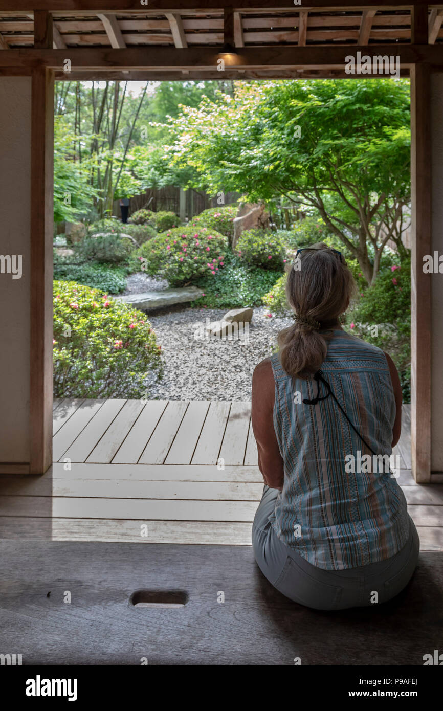 New Orleans, Louisiana - A woman contemplates the Japanese Garden in the New Orleans Botanical Garden. Stock Photo