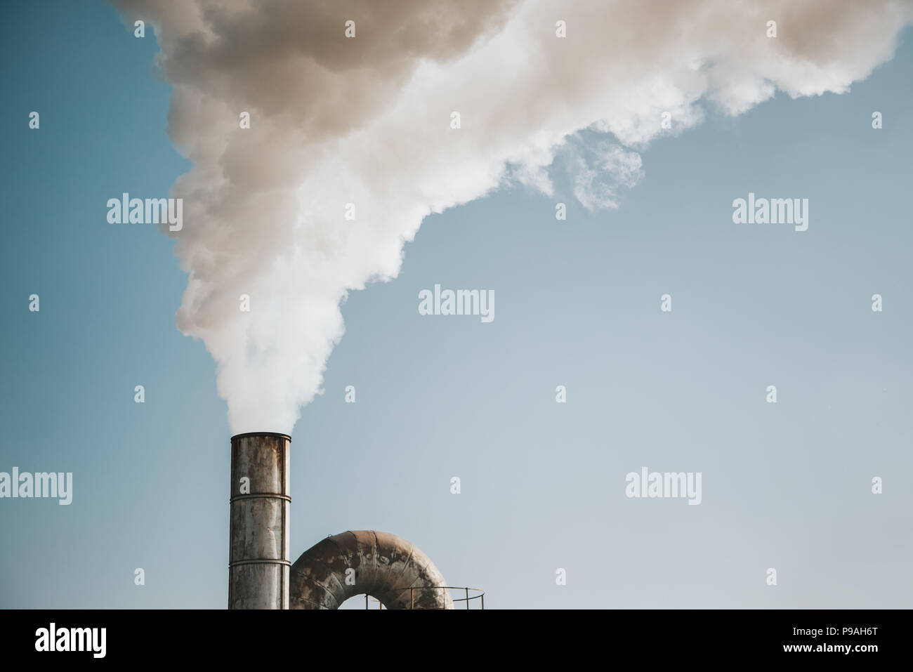 Air pollution by smoke coming out of factory chimneys Stock Photo