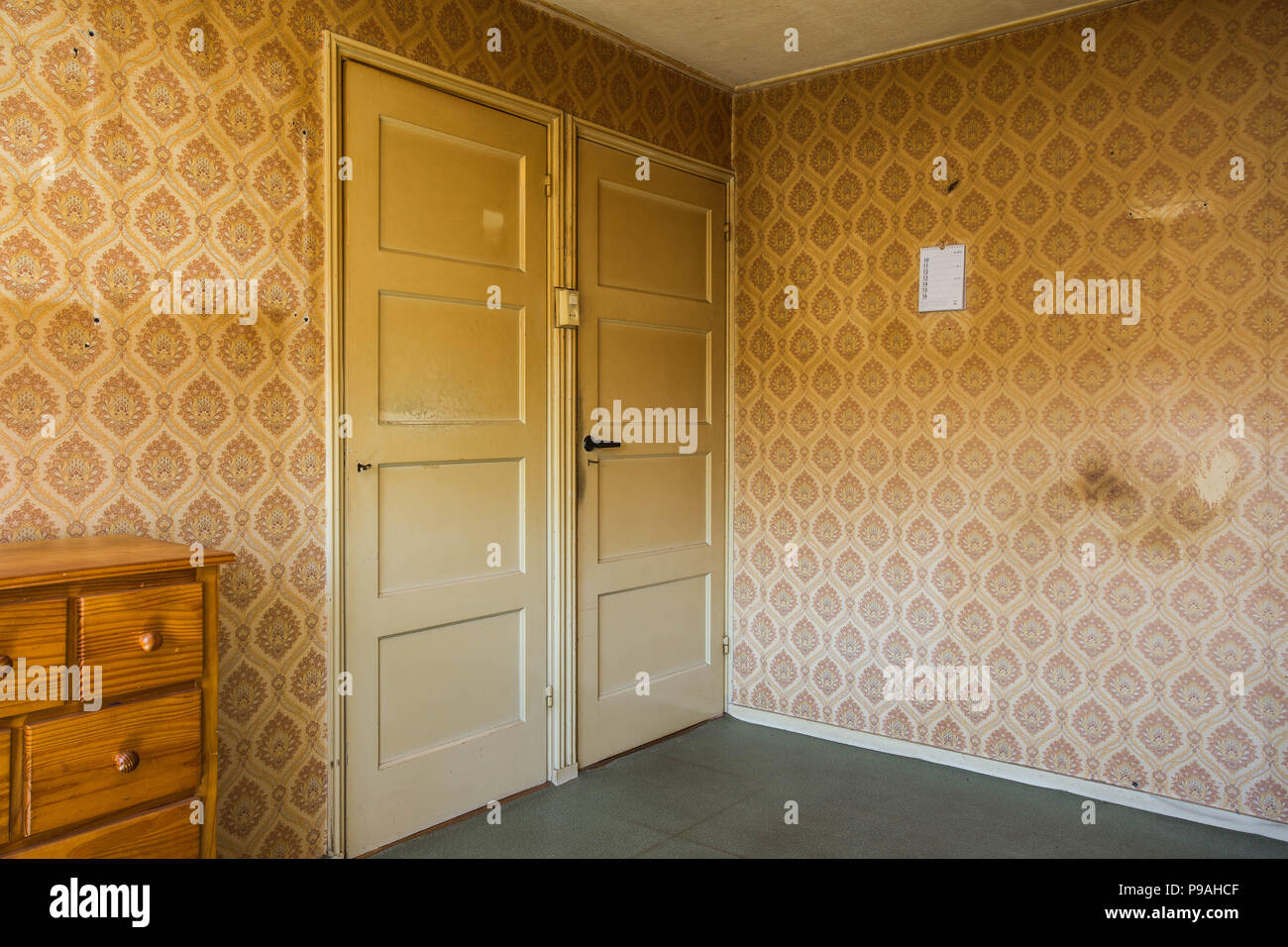 Vintage room with pattern wallpaper and old fashioned closet