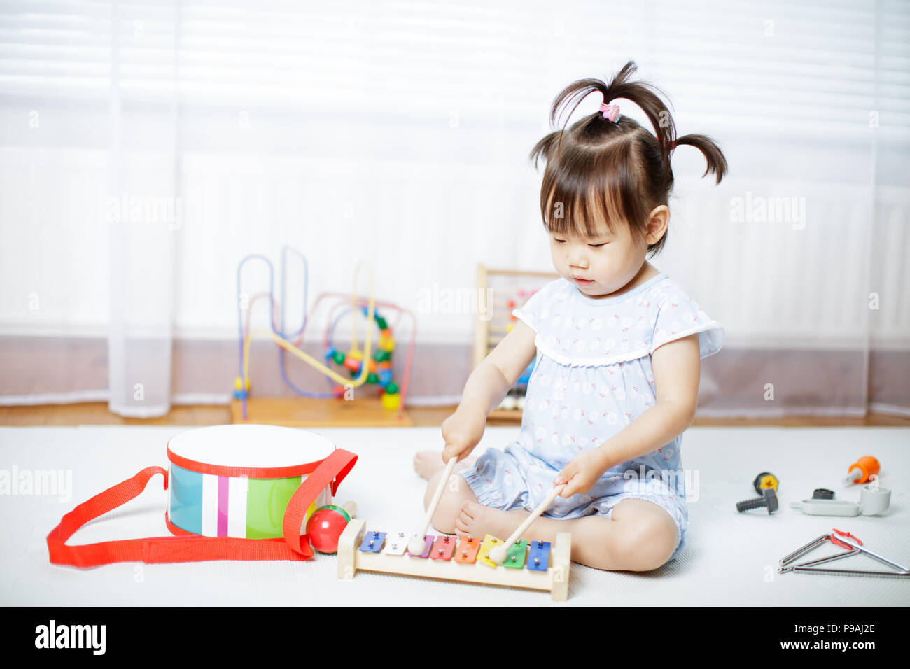 baby girl play xylophone at home Stock Photo Alamy