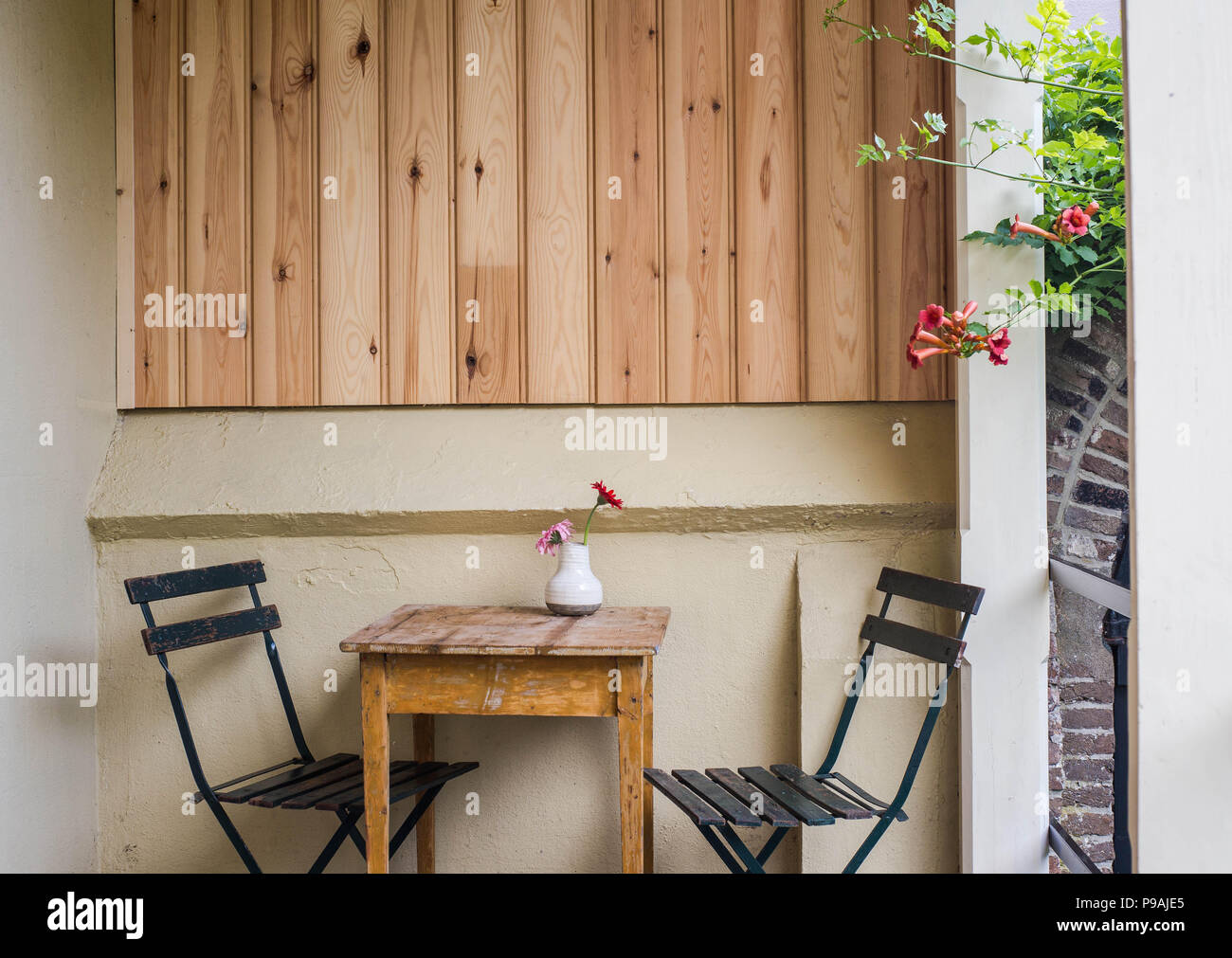 Beautiful cozy terrace or balcony with small table, chair and flowers