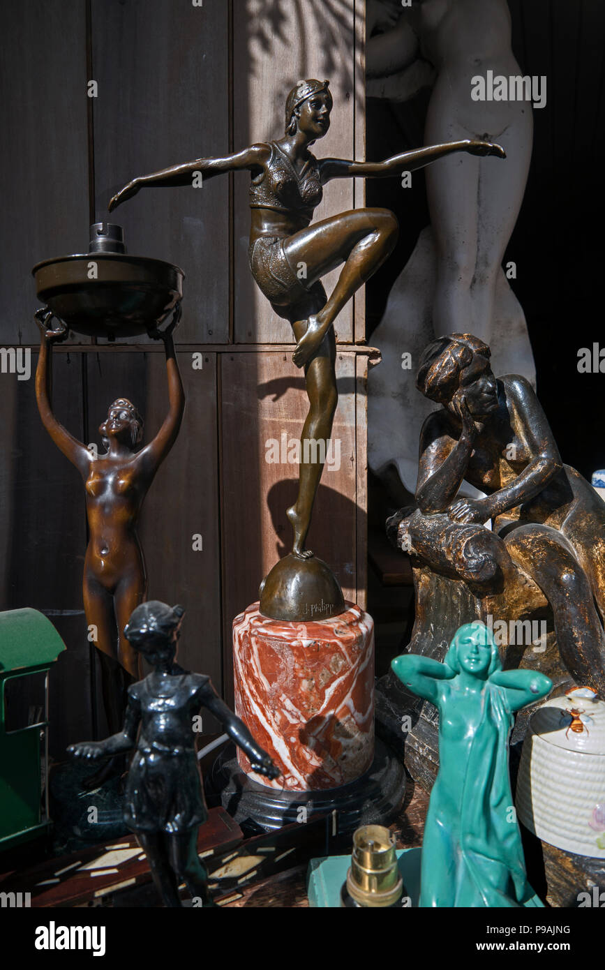 Art Deco figures on display in the window of an antique shop in