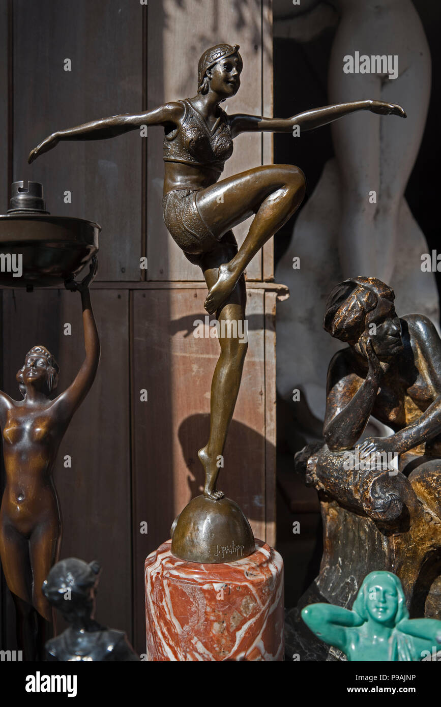 Art Deco figures on display in the window of an antique shop in