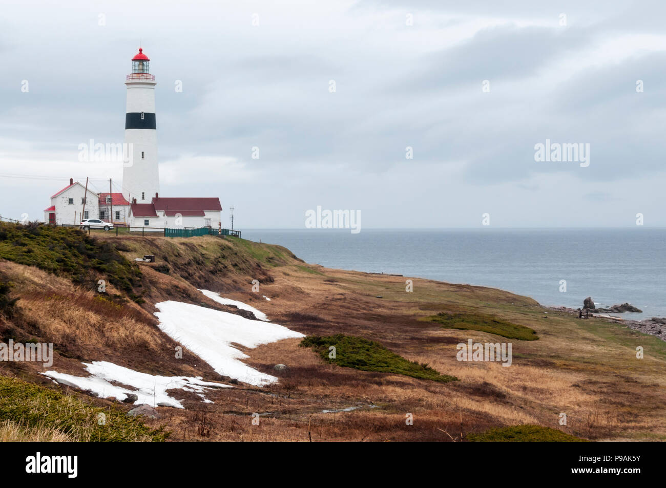 Remains of drifted snow in front of Point Amour Lighthouse in Labrador, Canada. Stock Photo