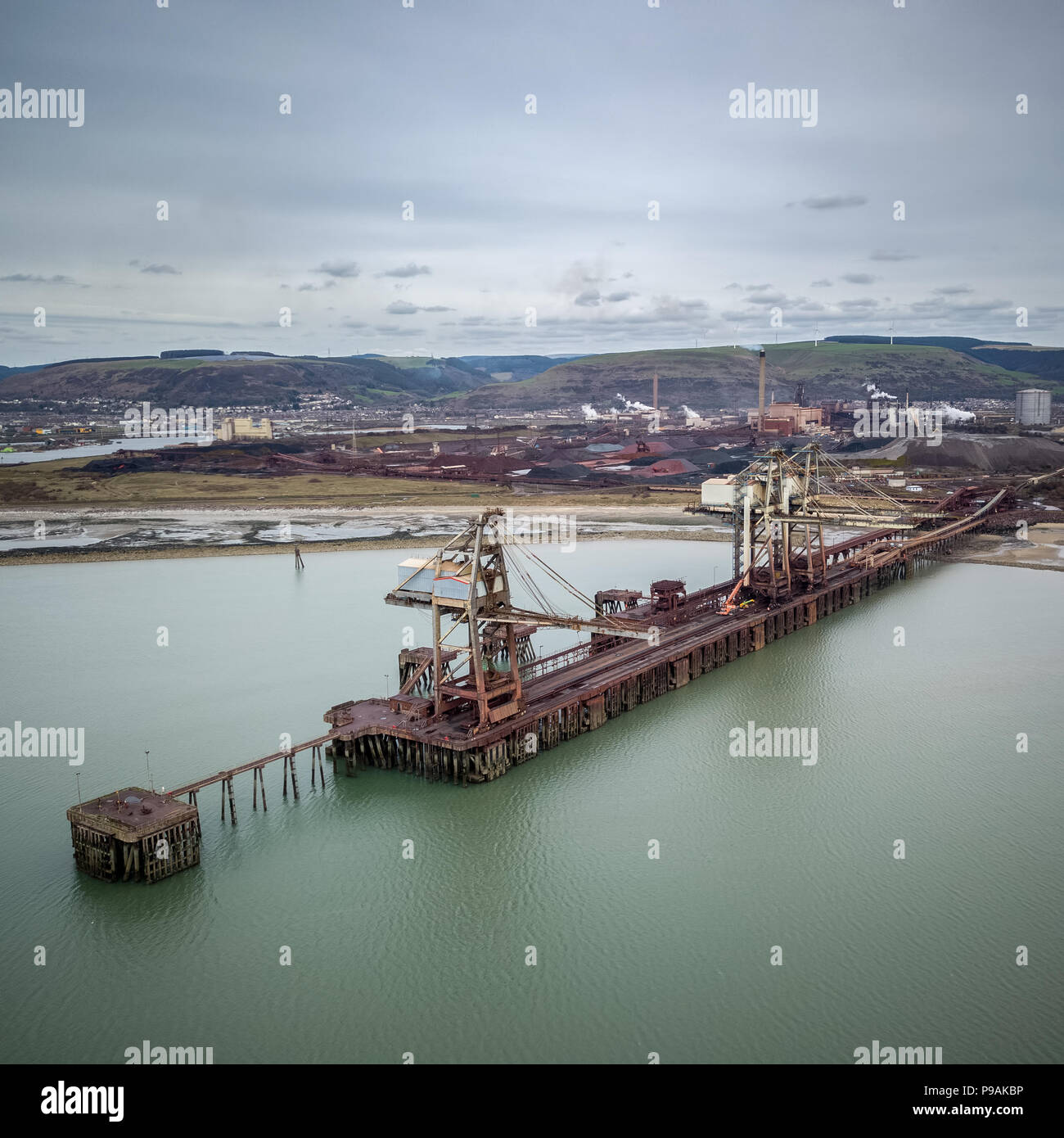 Photograph of the loading cranes on the deep water jetty at Port Talbot Steel Works in South Wales taken via Drone Stock Photo