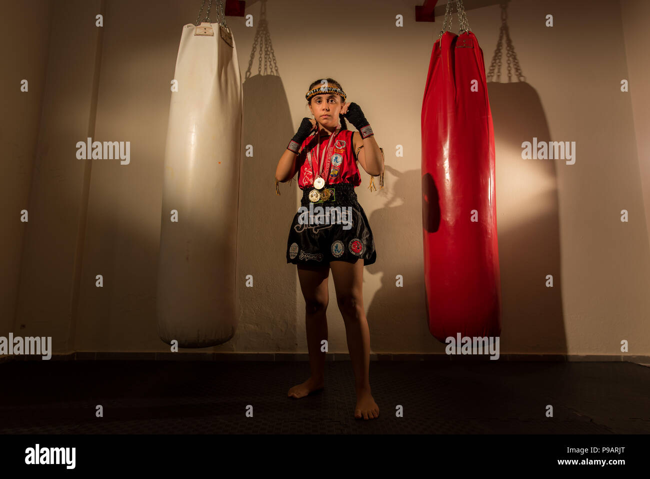 Young girl female junior kick boxer Muay Thai MMA boxing fighter Stock Photo