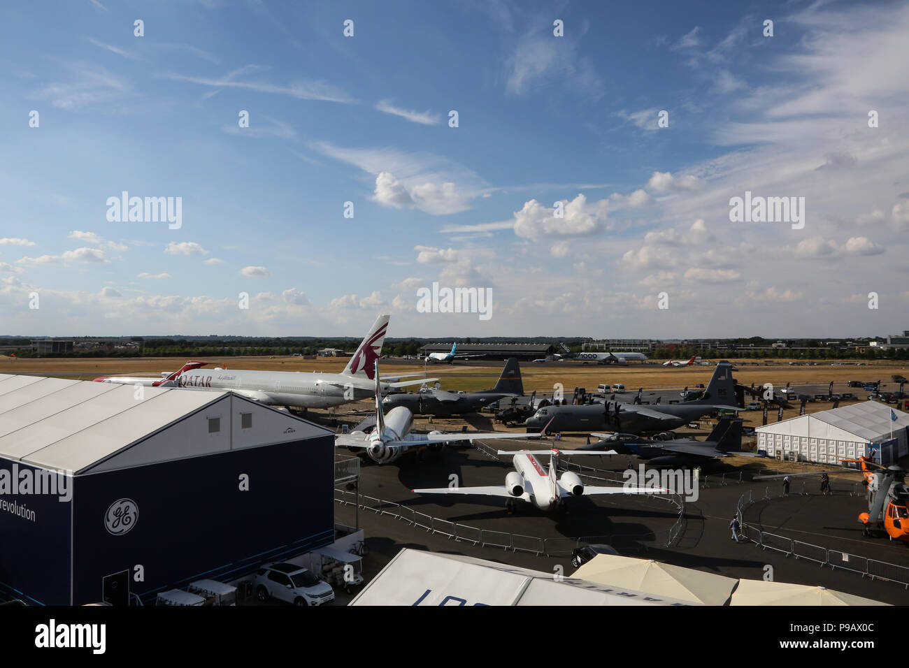 Farnborough, UK. 16th July 2018. A general view of aircraft from Boeing, Airbus, and Lockheed Martin which are parked at the end of the opening day of the 2018 Farnborough International Airshow, one of the biggest aviation trade and industry events in the world, held in the UK. Credit: James Hancock/Alamy Live News Stock Photo