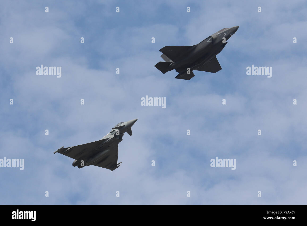 Farnborough, UK. 16th July 2018. A Royal Air Force Lockheed Martin F-35B and Eurofighter Typhoon perform a flypast on the opening day of the 2018 Farnborough International Airshow, one of the biggest aviation trade and industry events in the world, held in the UK. Credit: James Hancock/Alamy Live News Stock Photo