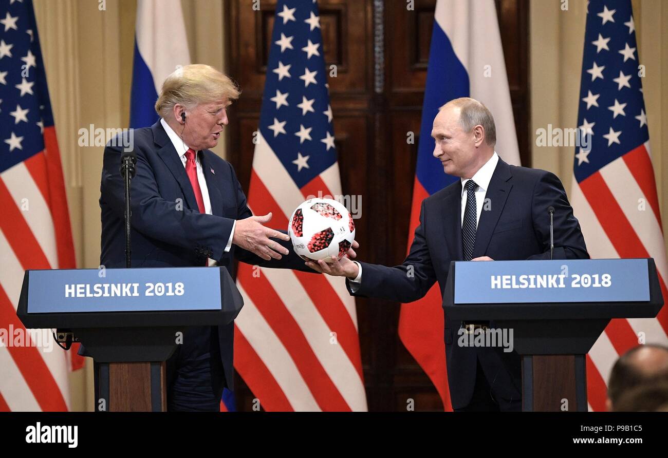 Helsinki, Finland. 16th July, 2018. Russian President Vladimir Putin presents a FIFA World Cup soccer ball to U.S. President Donald Trump during a joint press conference at the conclusion of the U.S. - Russia Summit meeting at the Presidential Palace July 16, 2018 in Helsinki, Finland. Credit: Planetpix/Alamy Live News Stock Photo