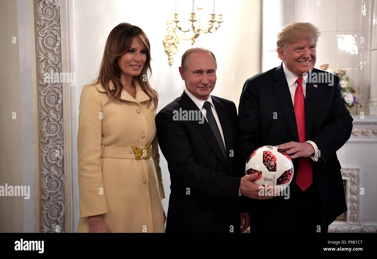 Helsinki, Finland. 16th July, 2018. Russian President Vladimir Putin, center, presents a FIFA World Cup soccer ball to U.S. President Donald Trump as First Lady Melania Trump looks on at the conclusion of the U.S. - Russia Summit meeting at the Presidential Palace July 16, 2018 in Helsinki, Finland. Credit: Planetpix/Alamy Live News Stock Photo