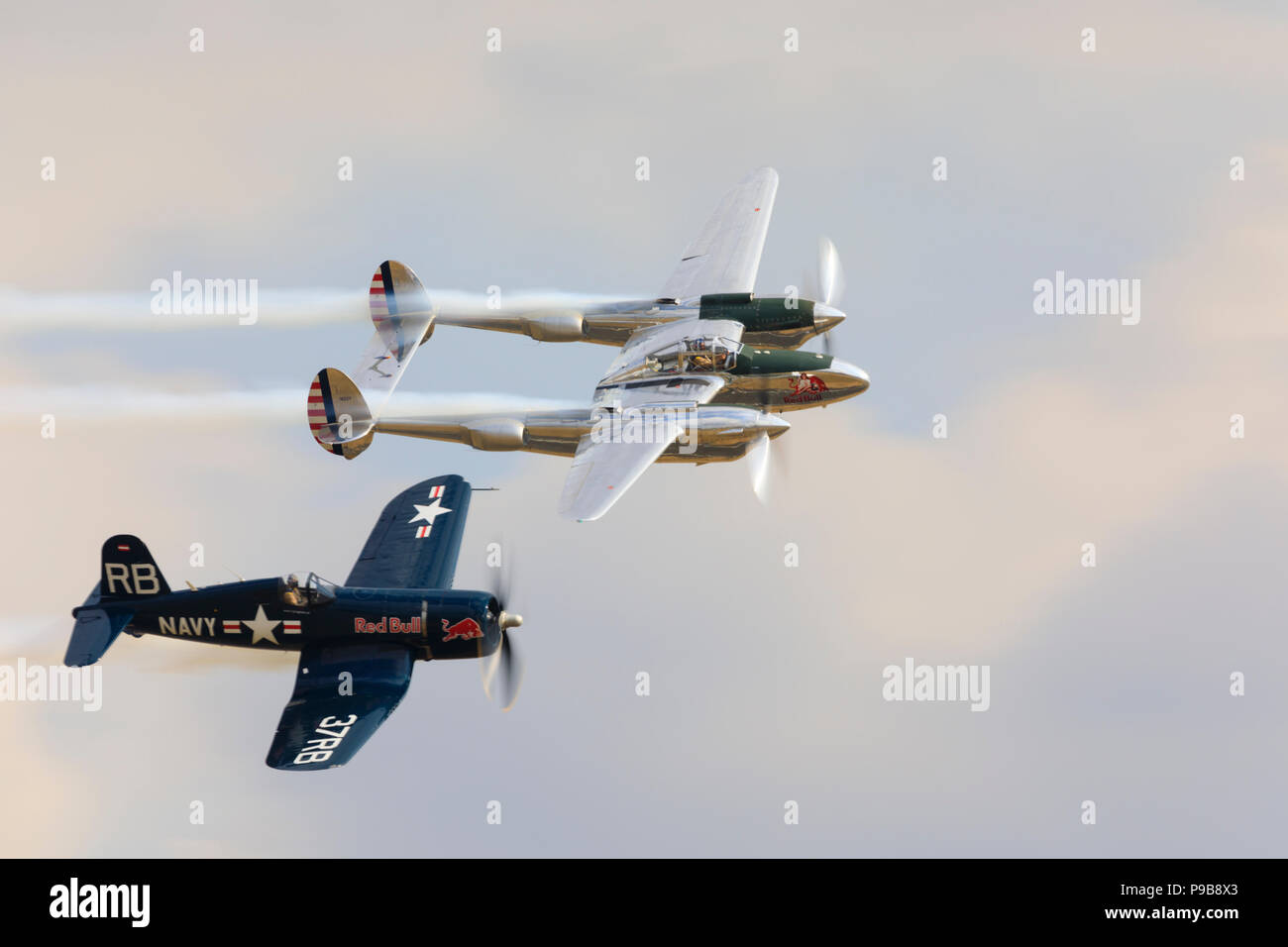 Chance Vought Corsair and Lockheed Lightning fighters fly in formation. Stock Photo
