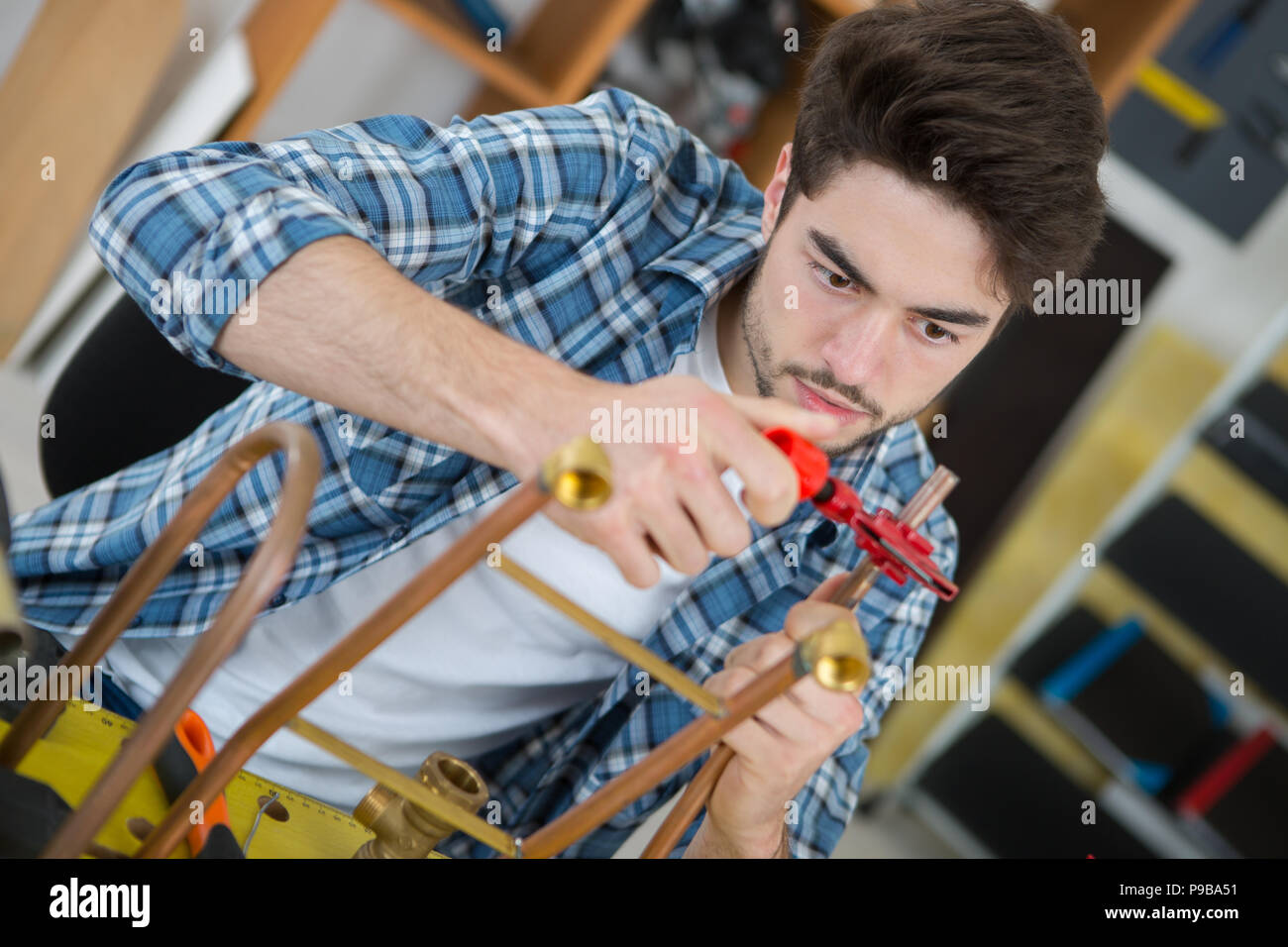 Worker clamping copper pipe Stock Photo Alamy