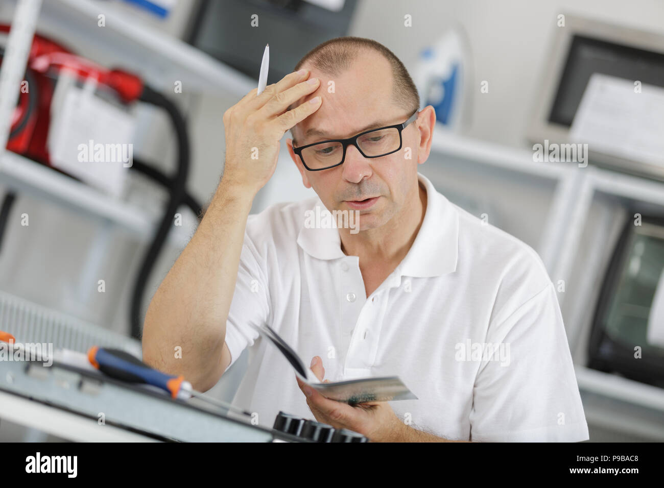 engineer looking in plan of air conditioning system Stock Photo Alamy