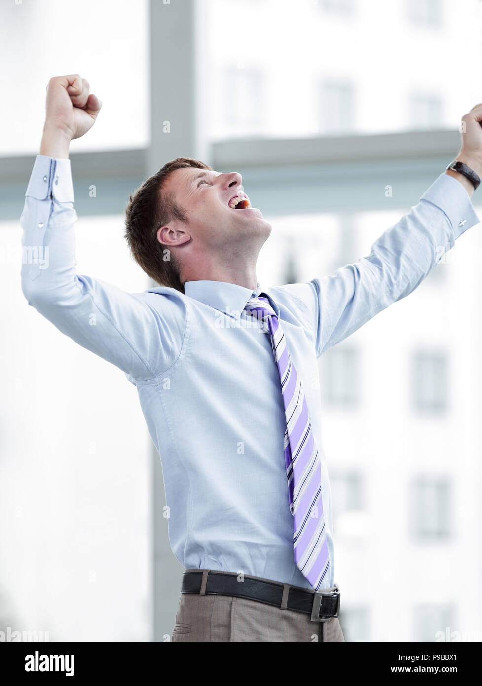 Businessman celebrating with his fists raised in the air Stock Photo ...