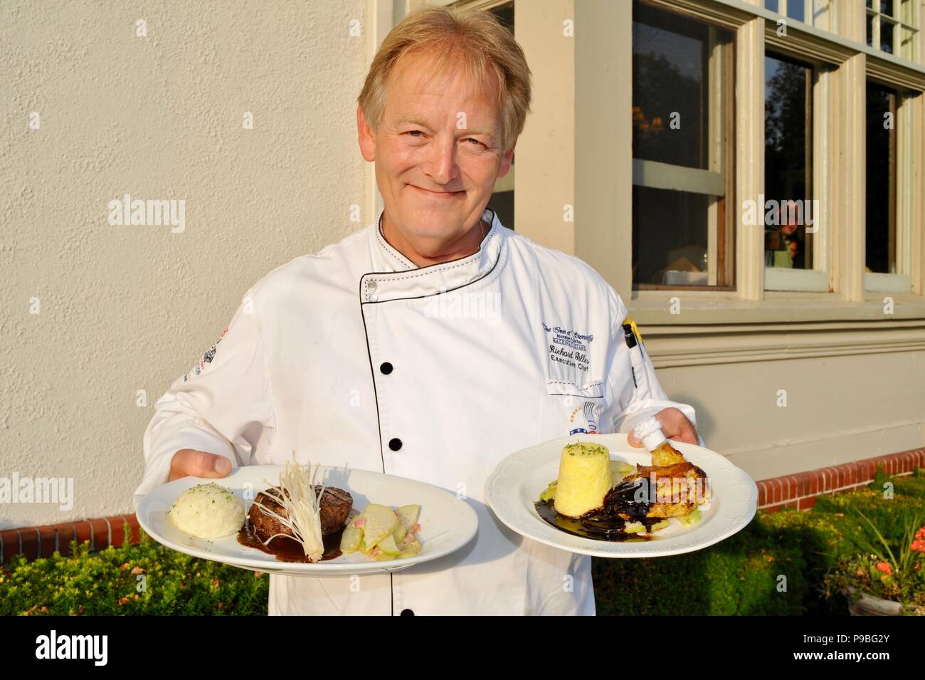 Executive Chef holding plated entrees to be served at The Cudahy Chophouse Restaurant at The Inn at Stonecliffe, Mackinac Island, Michigan, USA Stock Photo
