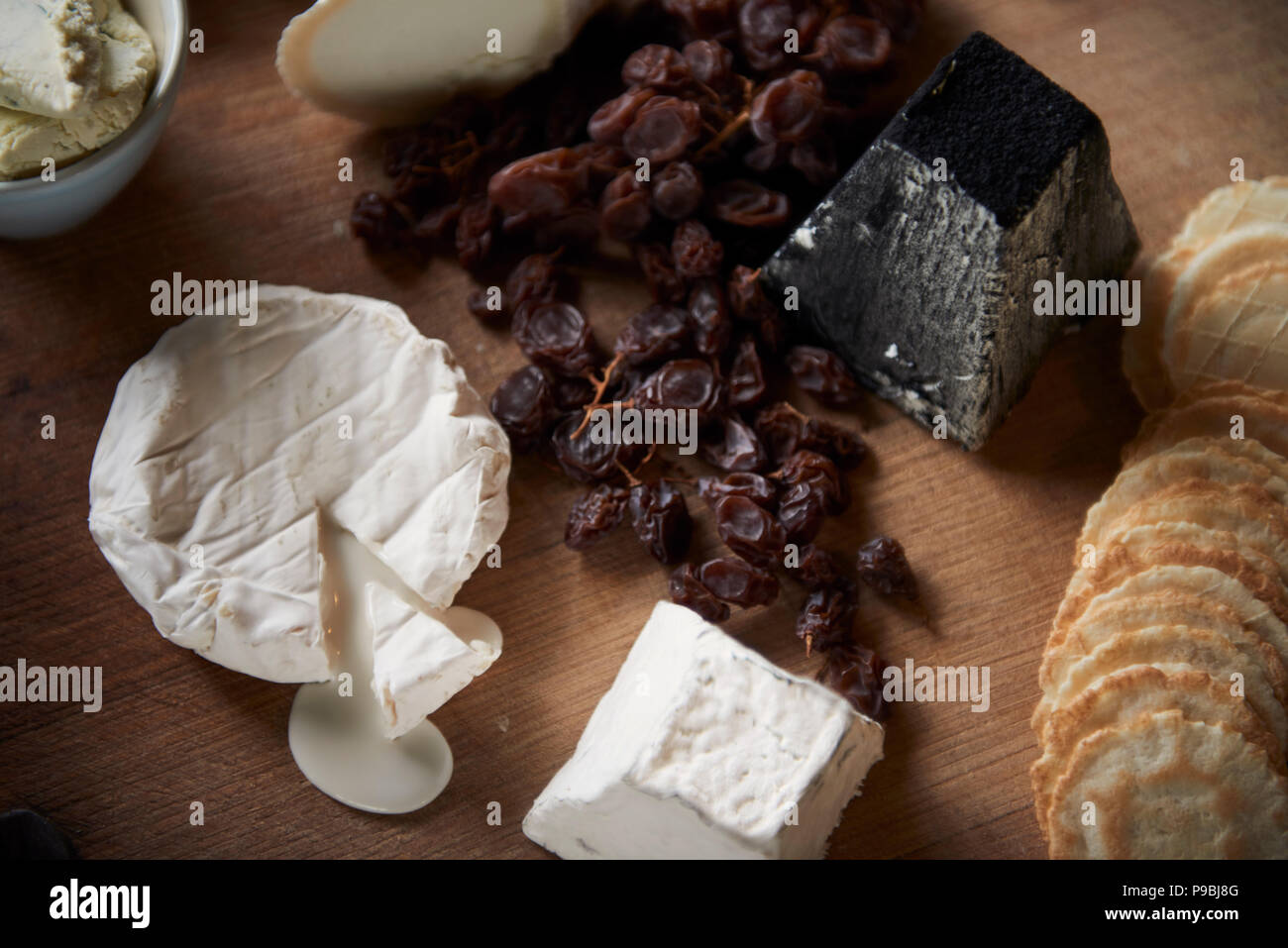 Generous heaving cheese and cracker board with wine. Stock Photo