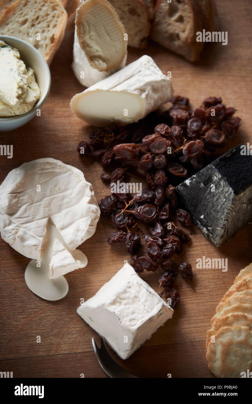 Generous heaving cheese and cracker board with wine. Stock Photo