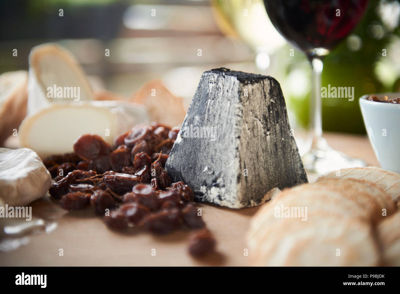 Generous heaving cheese and cracker board with wine. Stock Photo