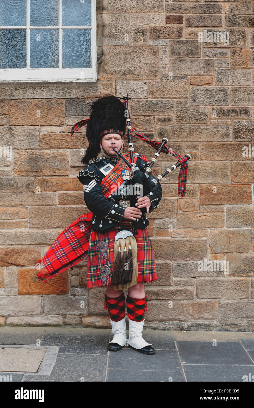 Man playing bagpipe in scottish traditional costume hires stock