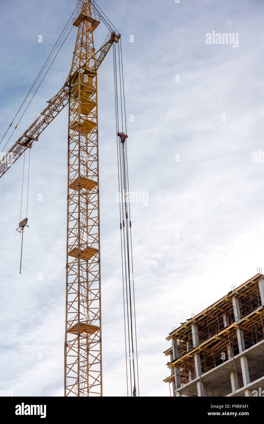 construction crane and high-rise building under construction against ...
