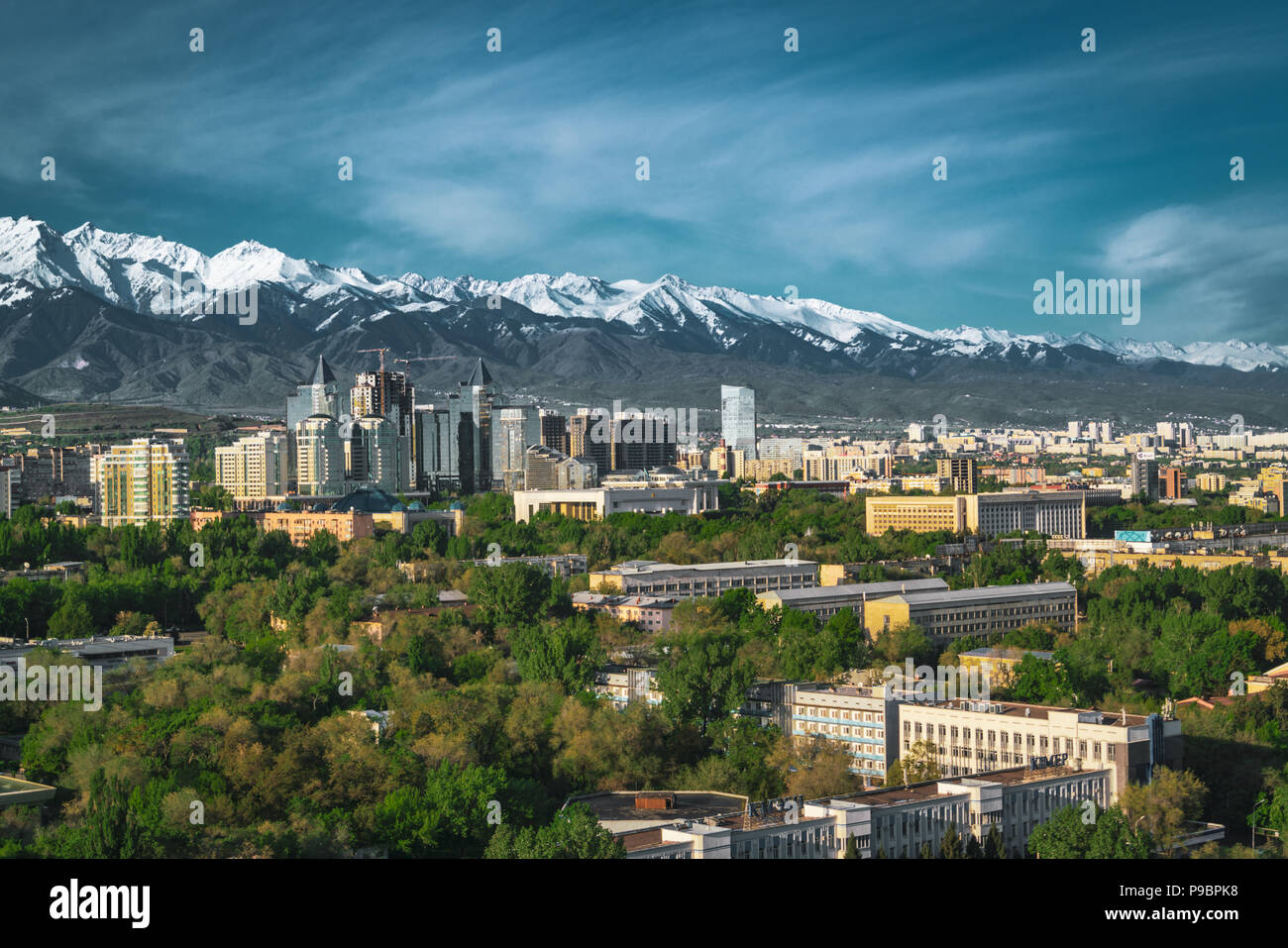 City landscape on a background of snow-capped Tian Shan mountains in Almaty Kazakhstan Stock Photo