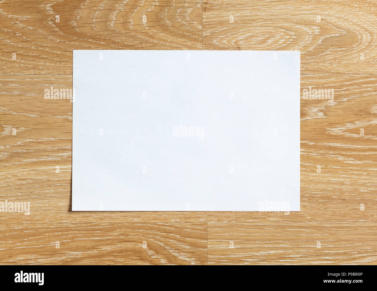 Blank sheet of paper landscape orientation on wooden background Stock Photo
