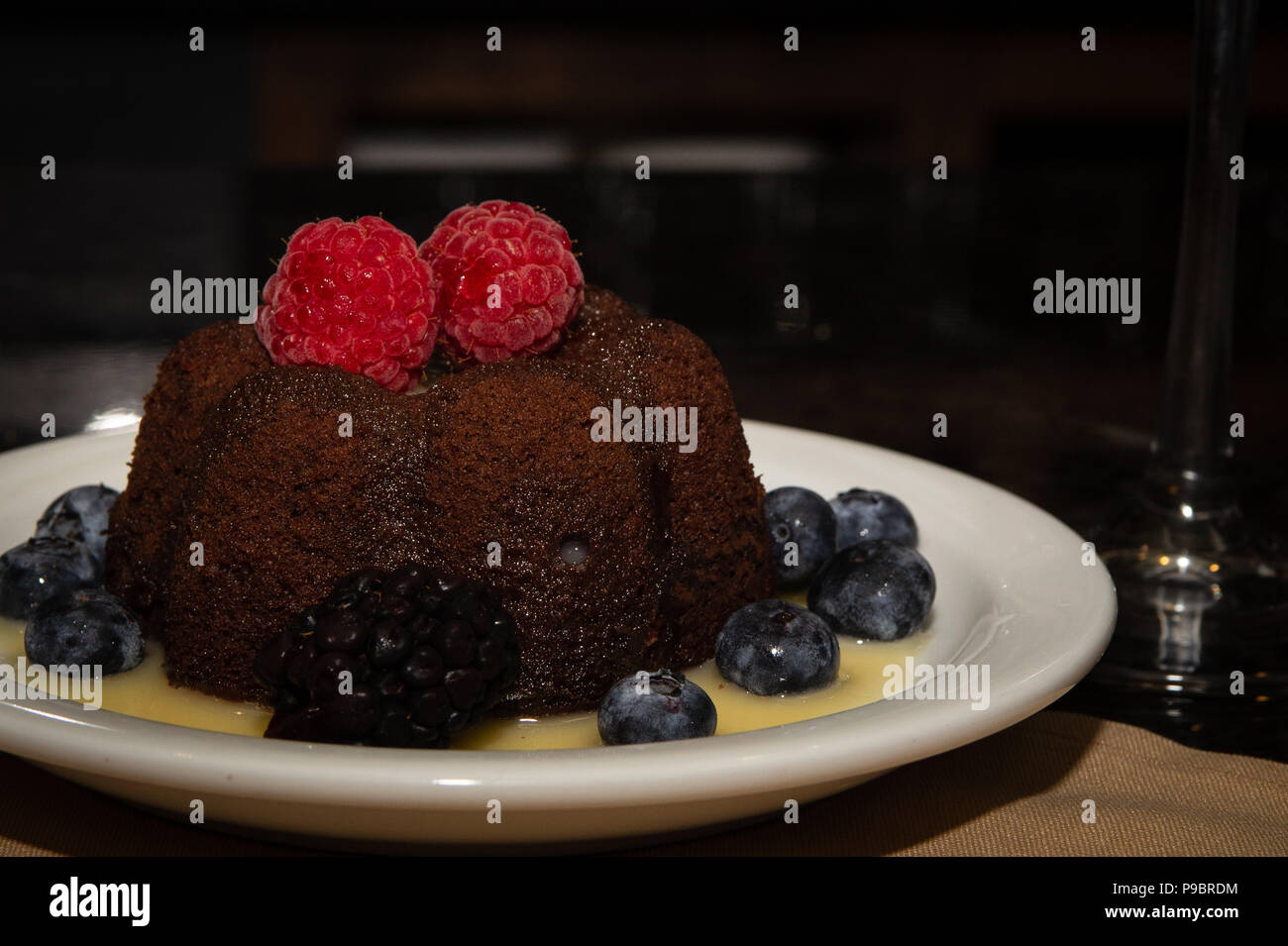 Molten Lava Cake with Berries and Syrup Stock Photo