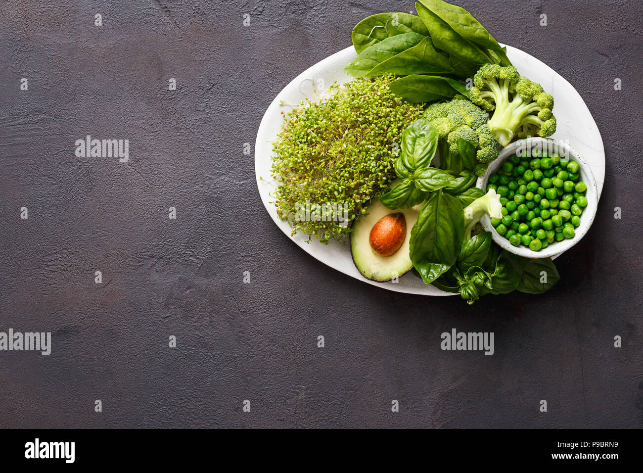 Healthy food clean eating selection source of protein for vegetarians: lucerne, spinach, basil, green peas, avocado and broccoli on dark background wi Stock Photo - Alamy Healthy food clean eating selection source of protein for vegetarians: lucerne, spinach, basil, green peas, avocado and broccoli on dark background wi Stock Photo - Alamy