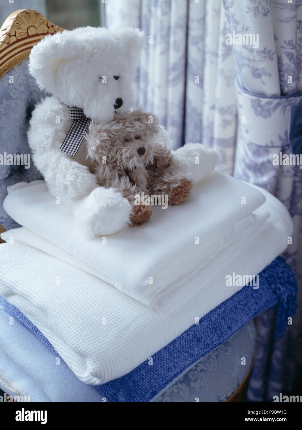 Close-up of teddybears on pile of white blankets Stock Photo