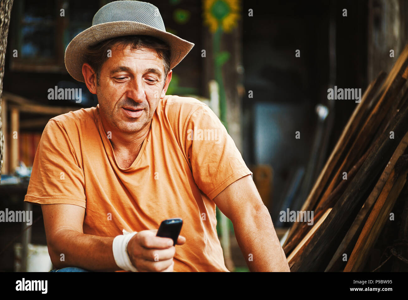 Portrait of an ordinary country man in Serbia, working and communicating with mobile. Stock Photo