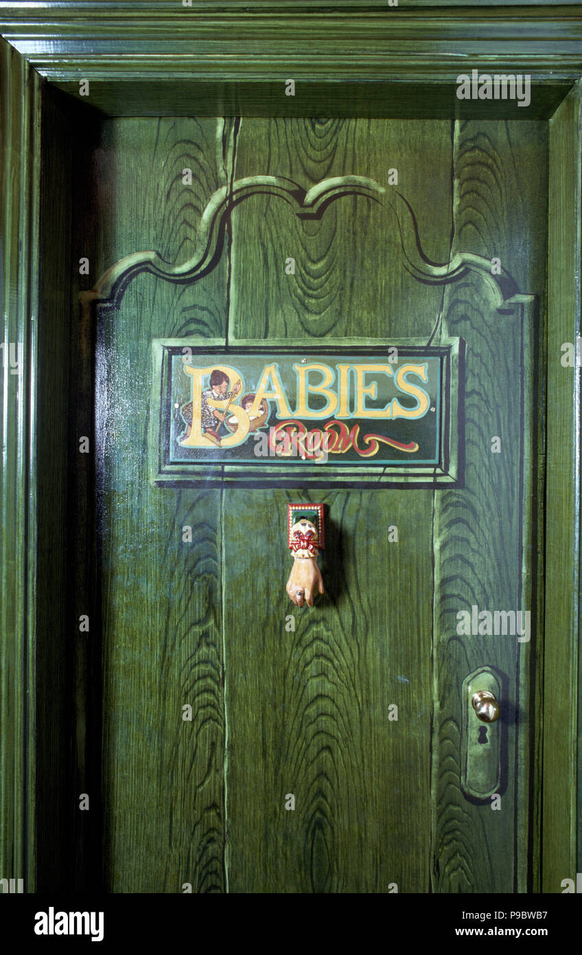 Close-up of painted door with 'Babies' sign Stock Photo