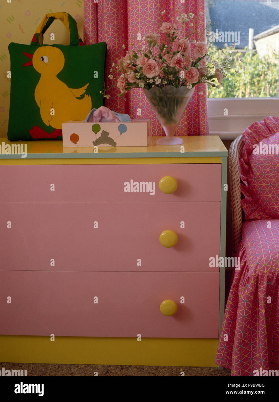 Pink painted chestofdrawers in child's eighties bedroom Stock Photo