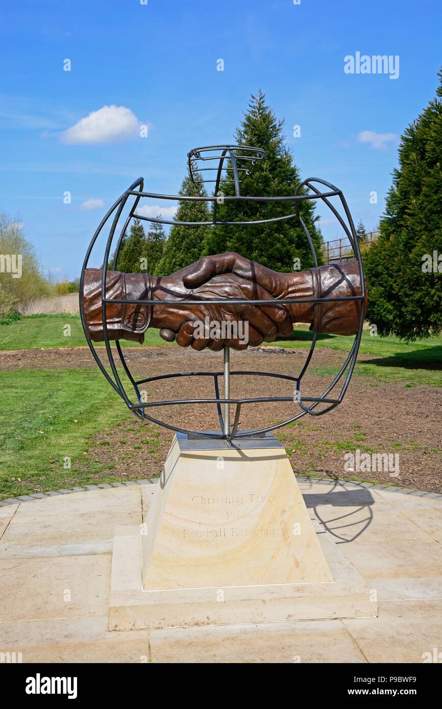 Christmas Truce Memorial showing soldiers handshake within a globe, National Memorial Arboretum, Alrewas, Staffordshire, England, UK, Western Europe. Stock Photo