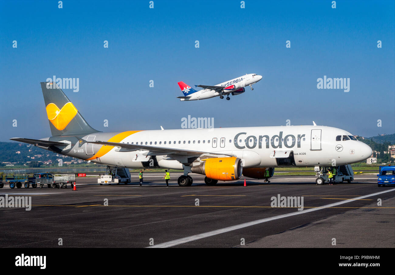 Airplane of Condor (D-AICD) on the apron and jet of Air Serbia (YU-APD) at take-off in the background Stock Photo